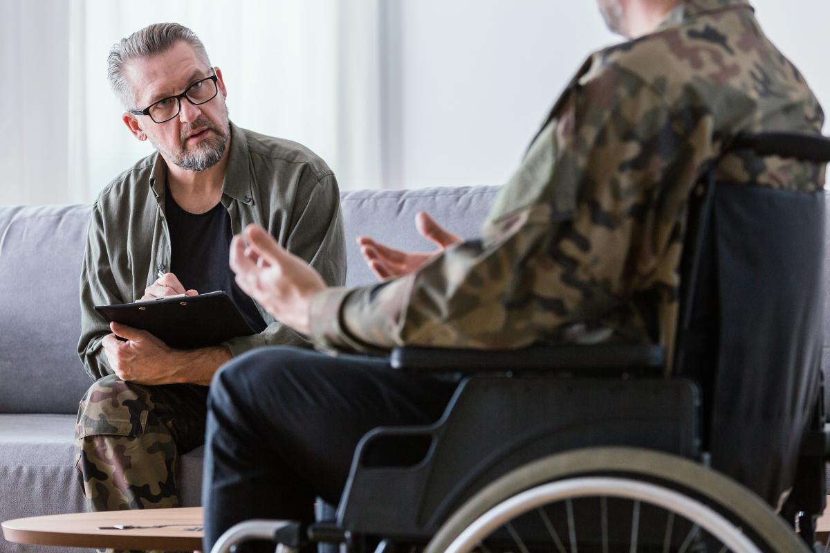 A financial advisor discusses loan options with a veteran.